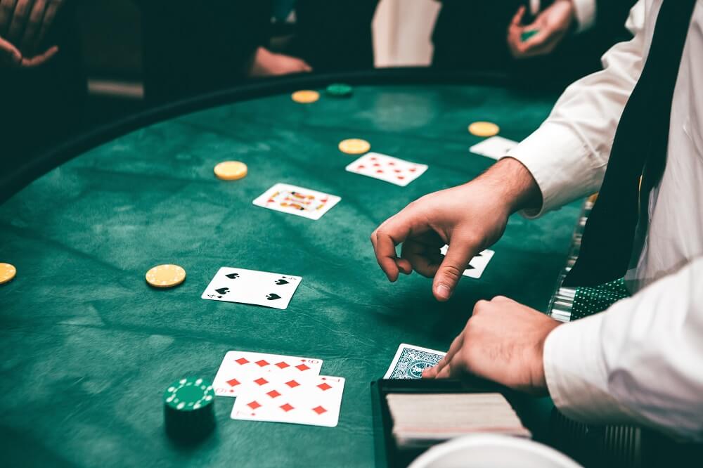 blackjack players and cards on table